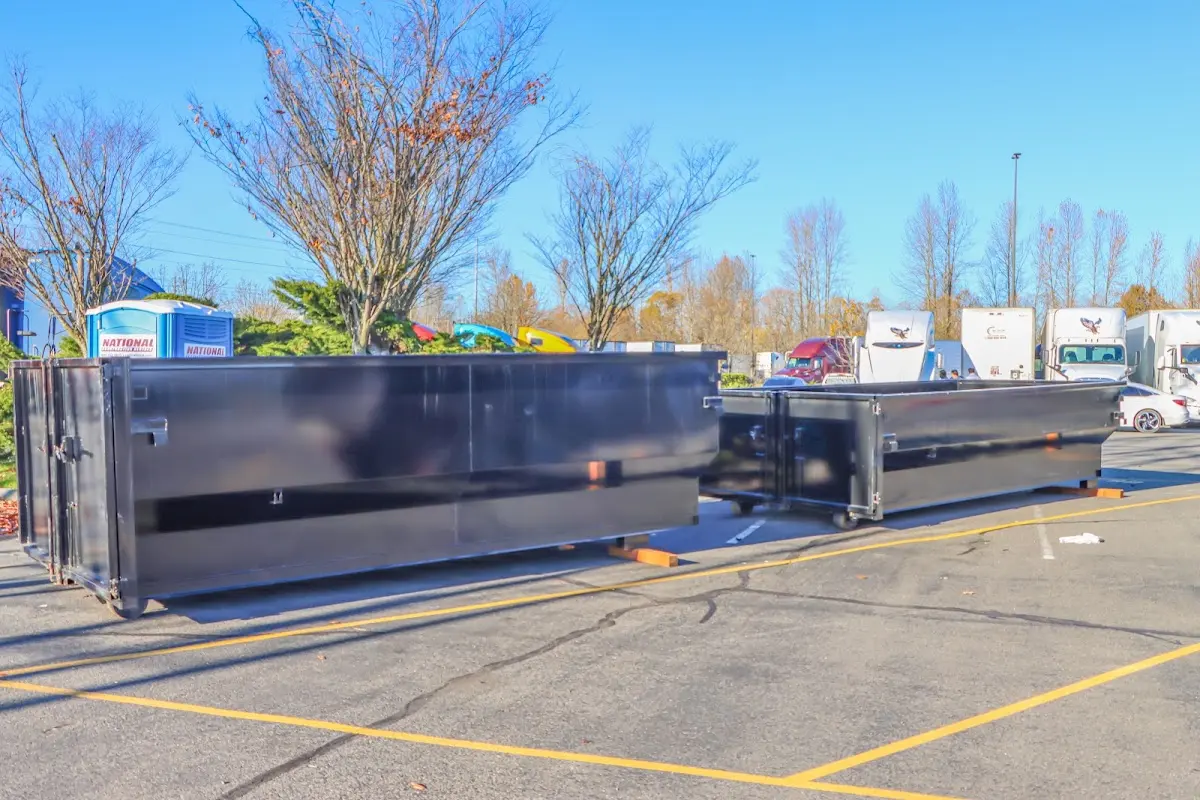 Professional dumpster rental service with roll-off container on residential driveway in Clarence